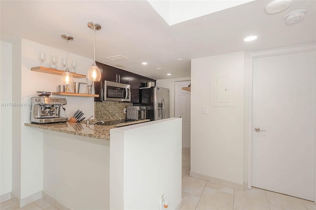 kitchen featuring kitchen peninsula, light stone countertops, stainless steel appliances, pendant lighting, and light tile patterned floors