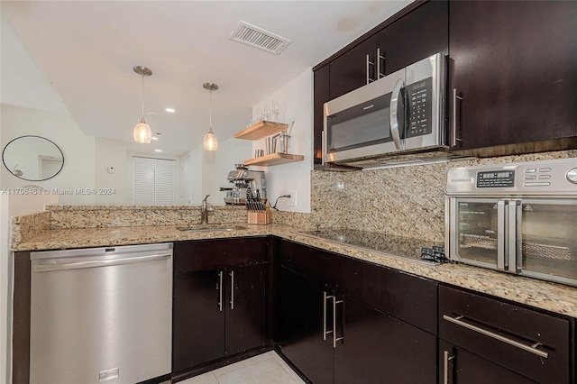 kitchen featuring sink, stainless steel appliances, tasteful backsplash, light stone counters, and light tile patterned floors