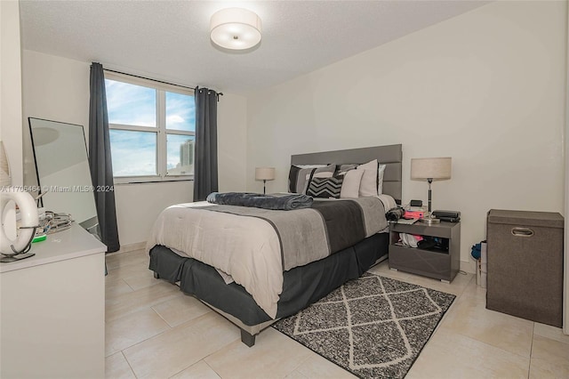 tiled bedroom featuring a textured ceiling