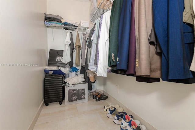 spacious closet featuring light tile patterned flooring