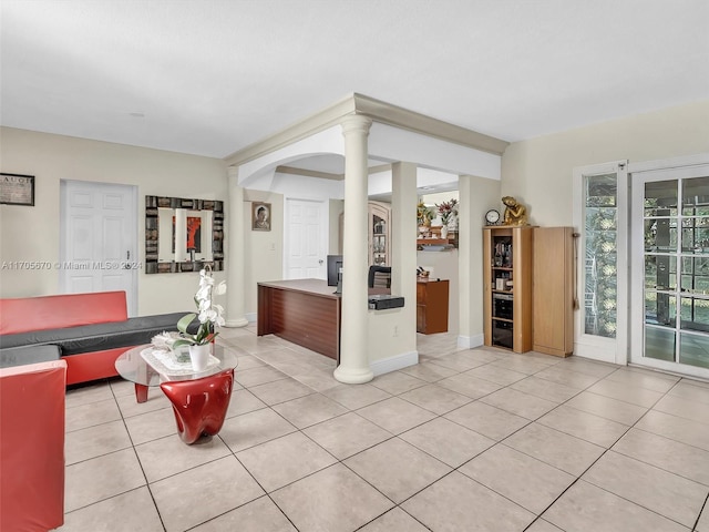 living room with light tile patterned floors and decorative columns