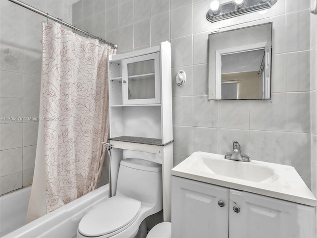 full bathroom featuring vanity, toilet, tile walls, and shower / tub combo