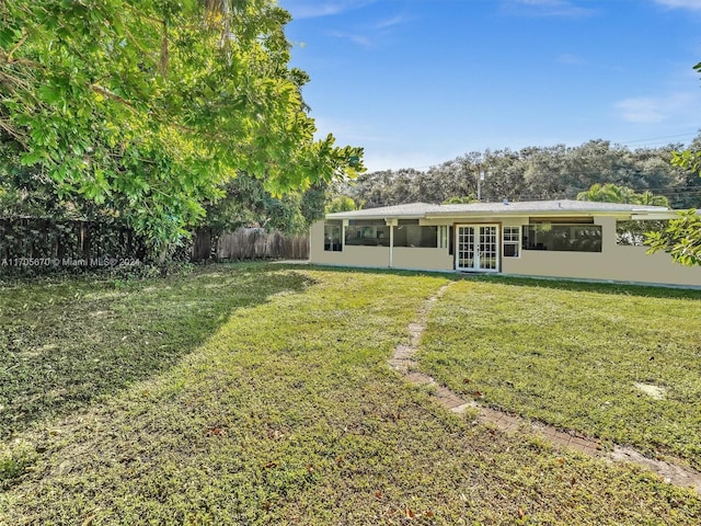 exterior space with a lawn and french doors
