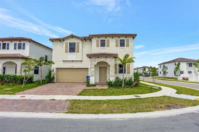 mediterranean / spanish home with a front yard and a garage