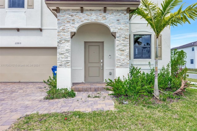 view of exterior entry with a garage