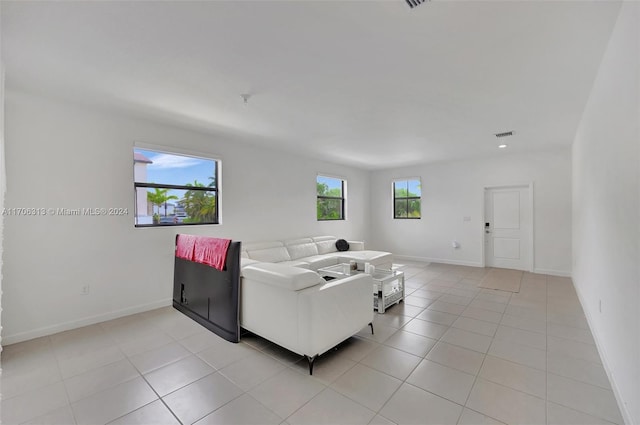 tiled living room featuring a wealth of natural light