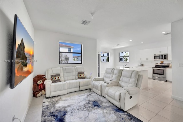 living room with light tile patterned floors and a textured ceiling