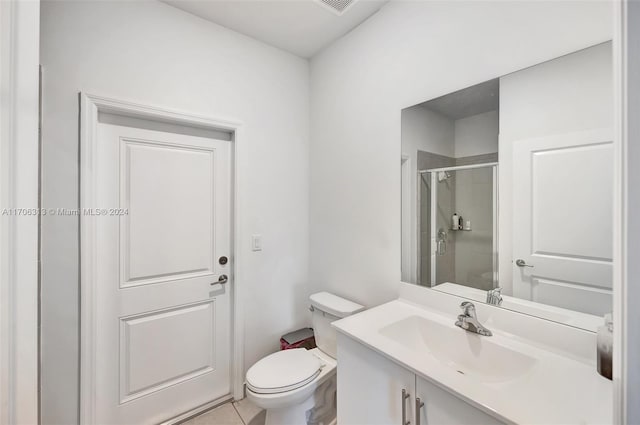 bathroom featuring tile patterned floors, vanity, toilet, and an enclosed shower