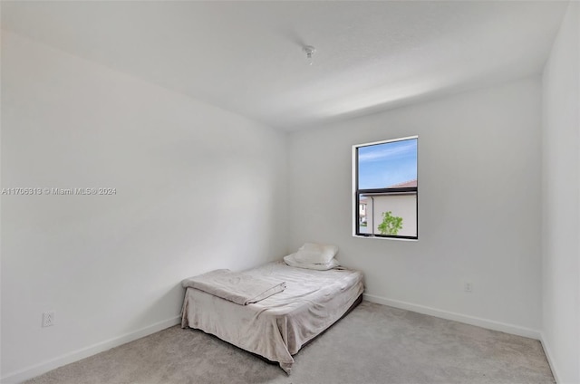 bedroom featuring light colored carpet