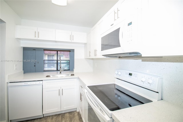 kitchen featuring white cabinets, white appliances, and sink