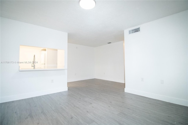 empty room with wood-type flooring