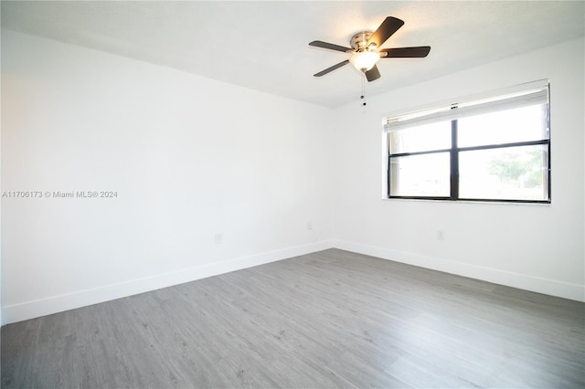 unfurnished room with hardwood / wood-style flooring and ceiling fan