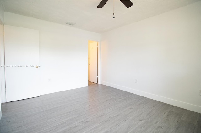 unfurnished room with hardwood / wood-style floors and ceiling fan