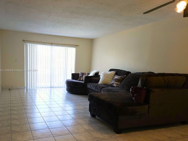 tiled living room with a textured ceiling and ceiling fan