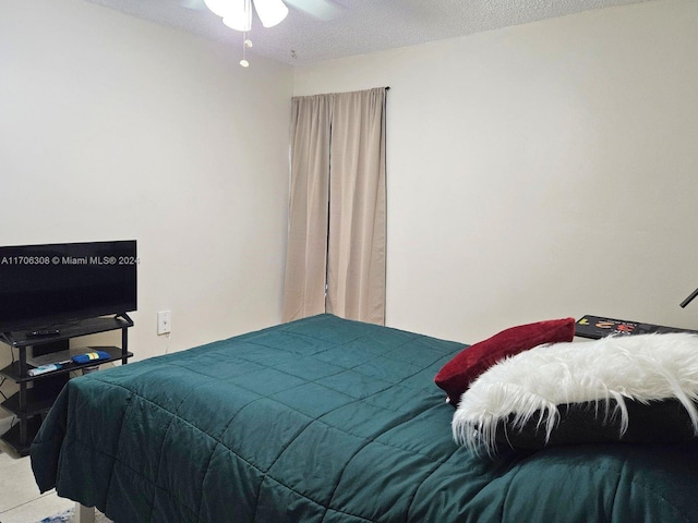 carpeted bedroom featuring ceiling fan and a textured ceiling