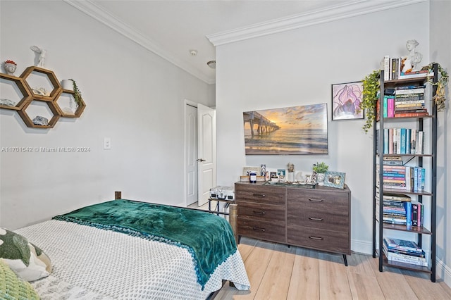 bedroom featuring light wood-type flooring and ornamental molding