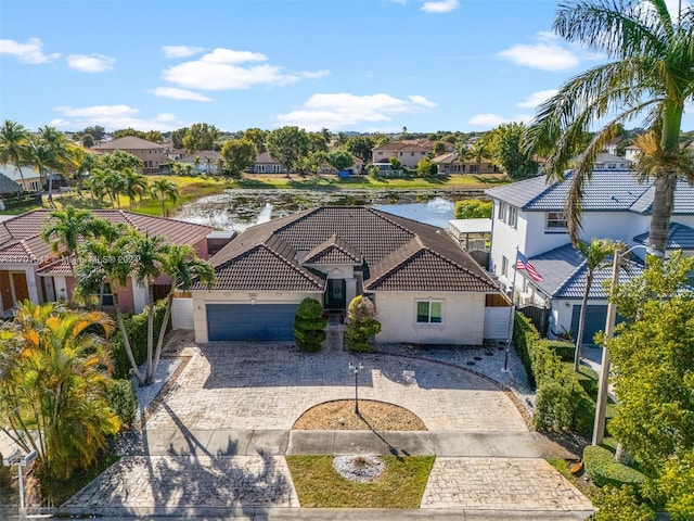 view of front of property with a garage and a water view