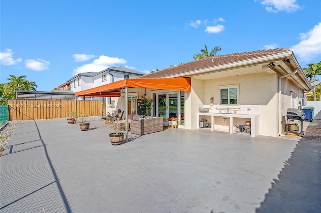 back of property featuring outdoor lounge area and a patio area