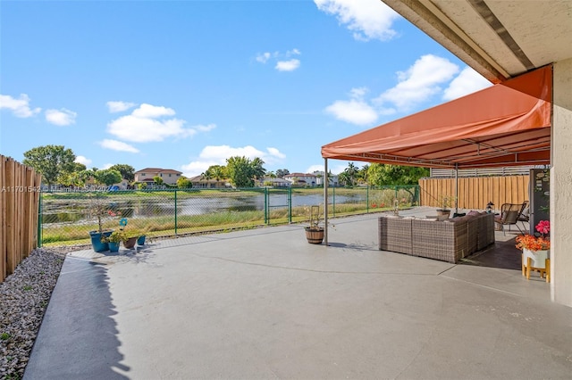 view of patio with outdoor lounge area and a water view