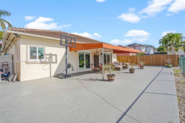 back of property with a patio area and an outdoor living space