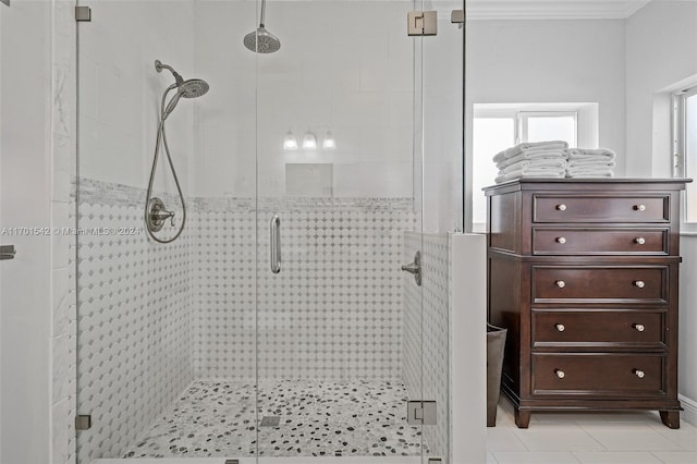 bathroom featuring tile patterned flooring, an enclosed shower, and ornamental molding