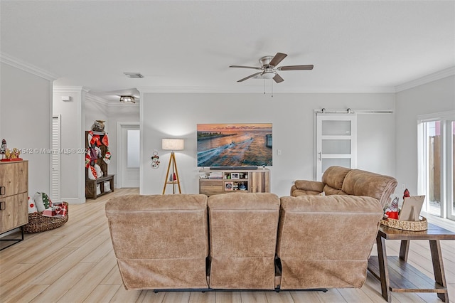 living room featuring light wood-type flooring, ceiling fan, and crown molding