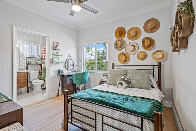 bedroom with ensuite bathroom, light hardwood / wood-style flooring, ceiling fan, and crown molding