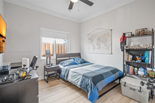 bedroom featuring light hardwood / wood-style floors, ceiling fan, and ornamental molding