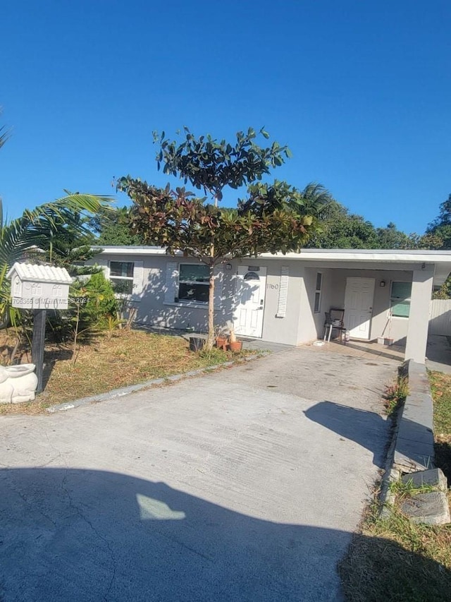 view of front of property featuring a carport