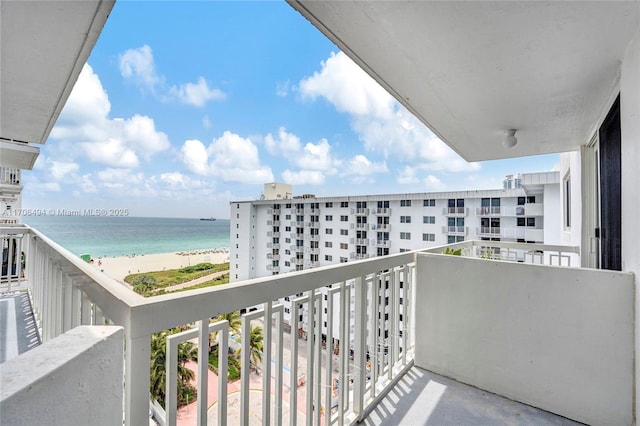 balcony featuring a beach view and a water view