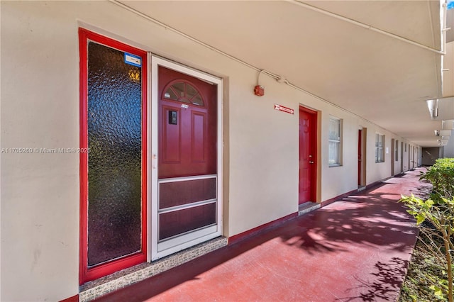 entrance to property with stucco siding