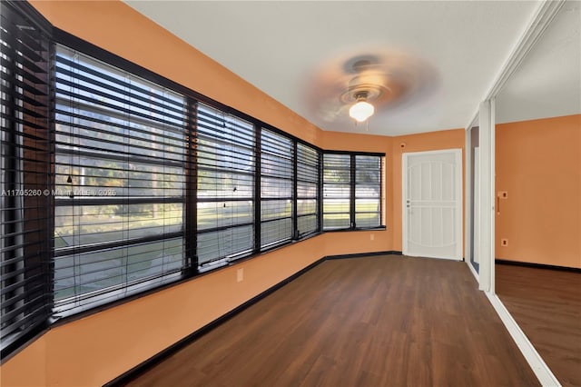 interior space with dark wood finished floors and baseboards