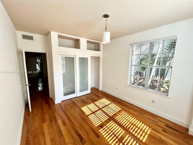 empty room with hardwood / wood-style floors