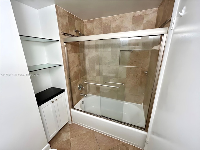 bathroom featuring tile patterned flooring and enclosed tub / shower combo