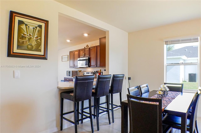 dining area with light tile patterned flooring