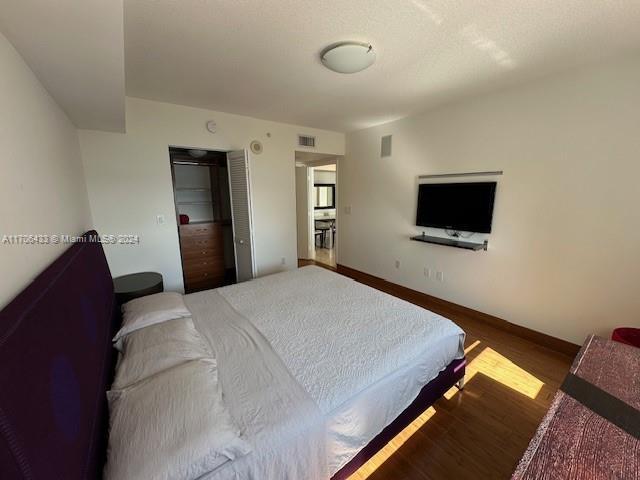 31 SE 5th St Unit 1908, Miami, FL 33131 - bedroom with wood finished floors and a closet