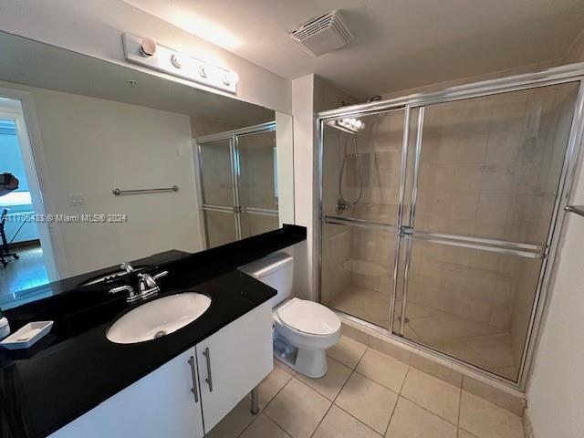 31 SE 5th St Unit 1908, Miami, FL 33131 - bathroom with tile patterned floors, vanity, and a stall shower