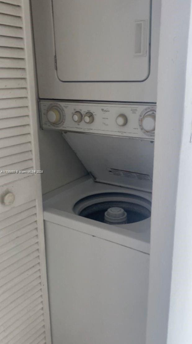 laundry area with stacked washer / drying machine