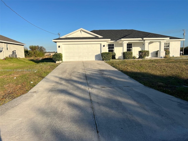 single story home featuring central AC unit, a garage, and a front lawn