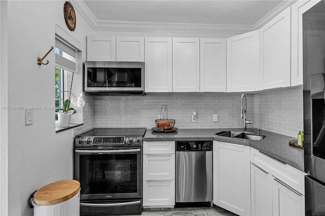 kitchen featuring crown molding, sink, white cabinetry, and stainless steel appliances