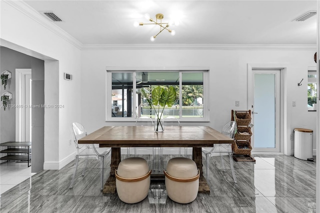 dining area featuring ornamental molding and an inviting chandelier