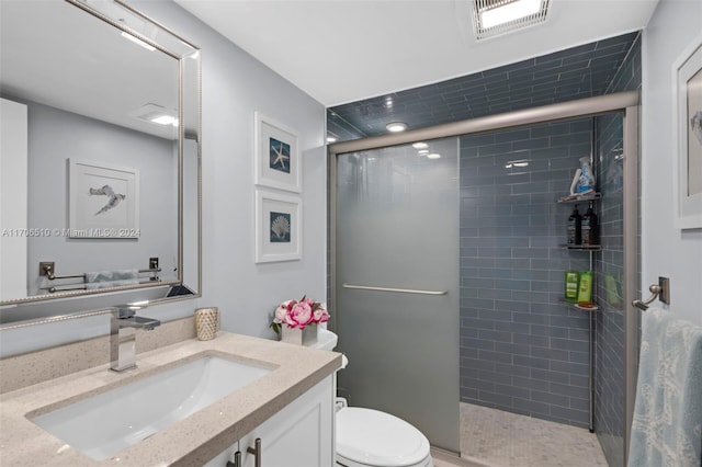 bathroom with vanity, an enclosed shower, and toilet