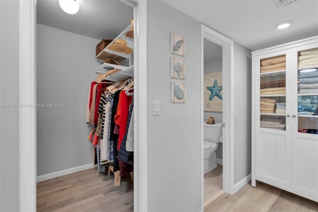 spacious closet with light hardwood / wood-style floors