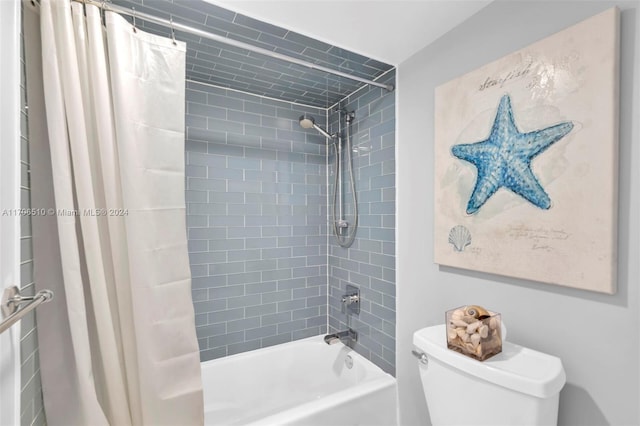 bathroom with shower / bath combo and toilet