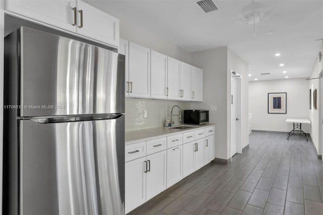 821 Cypress Blvd Unit 304, Pompano Beach, FL 33069 - kitchen with freestanding refrigerator, a sink, black microwave, backsplash, and light countertops