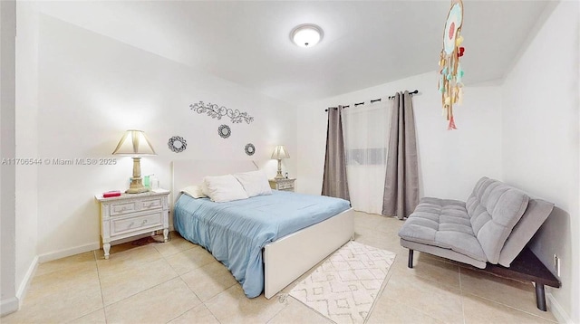 bedroom featuring baseboards and tile patterned floors