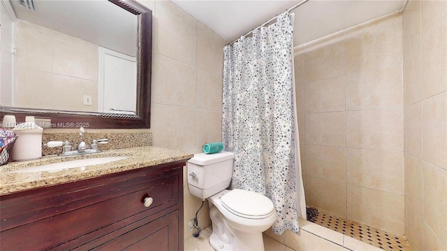 full bathroom featuring toilet, vanity, tile walls, and a shower stall