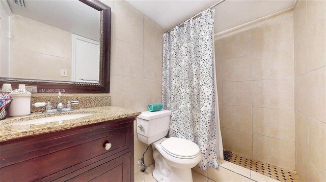 10421 SW 157th Pl Unit 206, Miami, FL 33196 - full bathroom featuring toilet, vanity, tile walls, and a shower stall