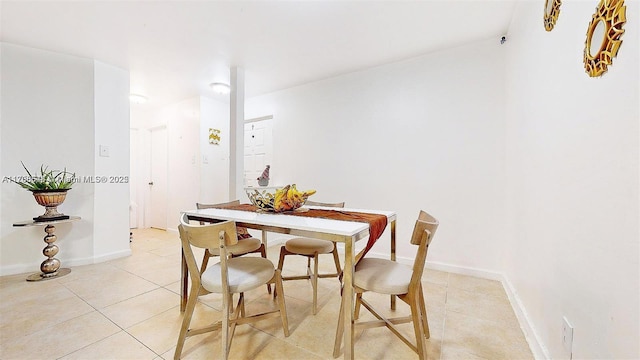 dining room with baseboards and light tile patterned floors