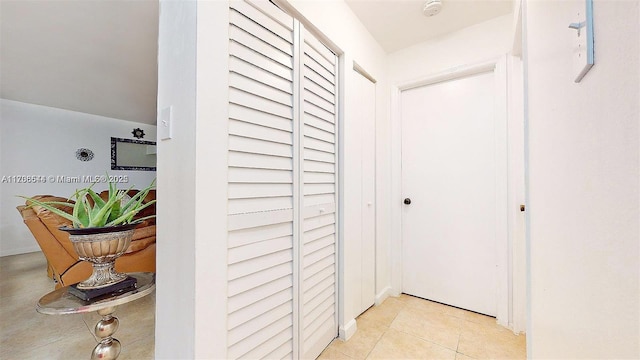 hall with light tile patterned flooring